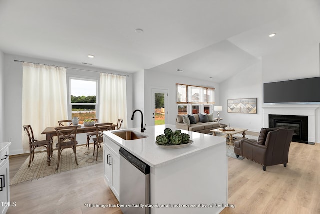 kitchen with a sink, stainless steel dishwasher, plenty of natural light, light countertops, and recessed lighting