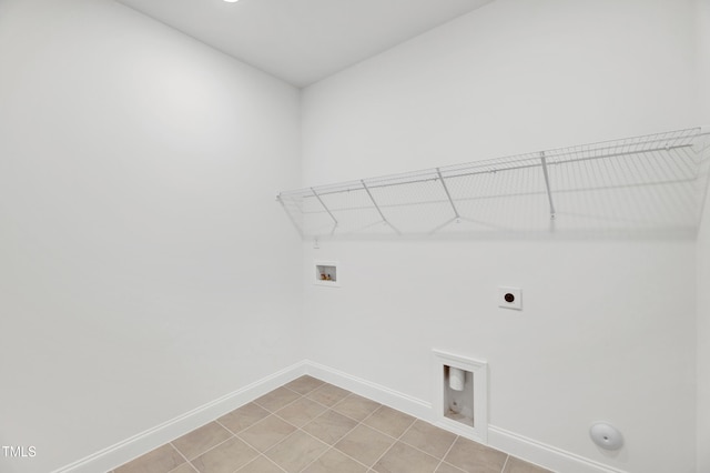 washroom with hookup for a washing machine, hookup for an electric dryer, baseboards, gas dryer hookup, and light tile patterned floors