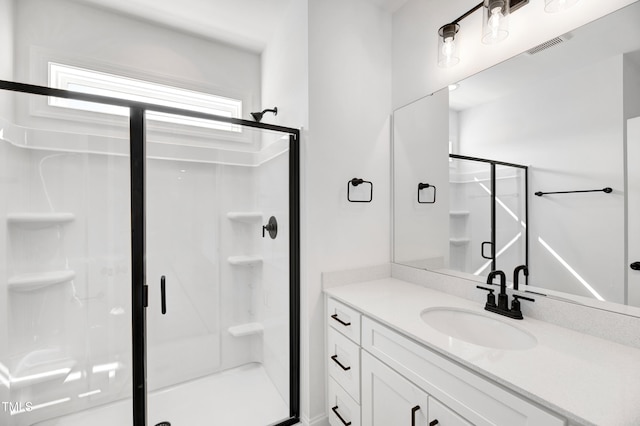 bathroom featuring a stall shower and vanity