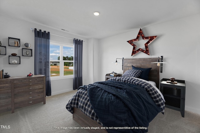 bedroom featuring carpet and baseboards