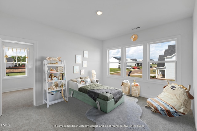 bedroom featuring carpet, multiple windows, and baseboards