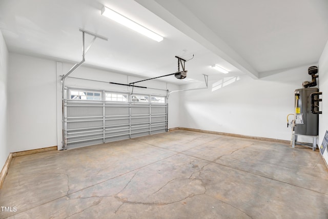 garage featuring water heater, a garage door opener, and baseboards