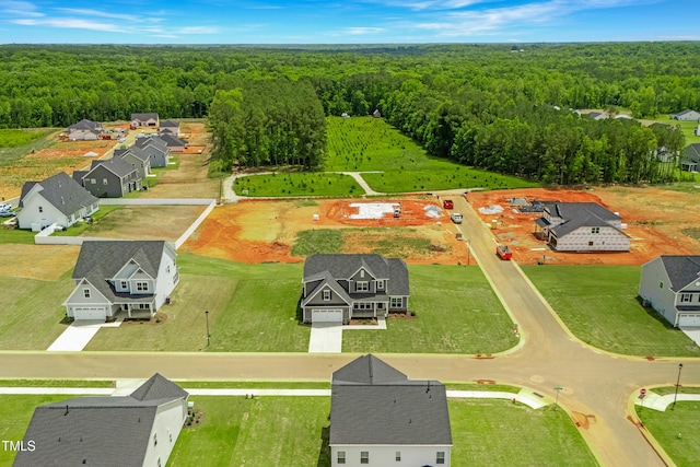 aerial view of residential area featuring a forest