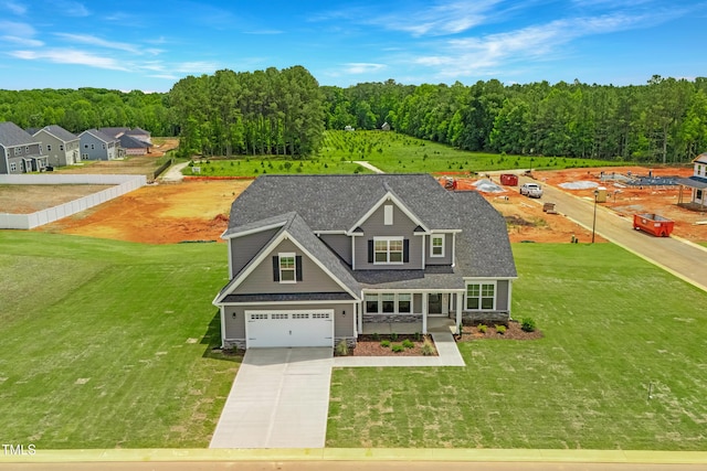 view of front of house featuring driveway, an attached garage, a front yard, and a shingled roof