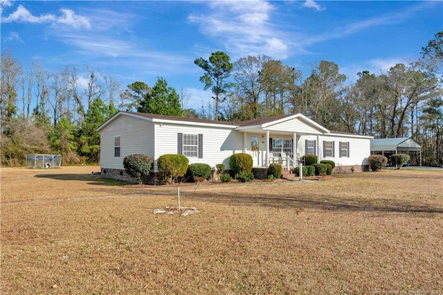 view of front of property featuring covered porch and a front yard