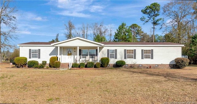 manufactured / mobile home with a porch, crawl space, and a front lawn