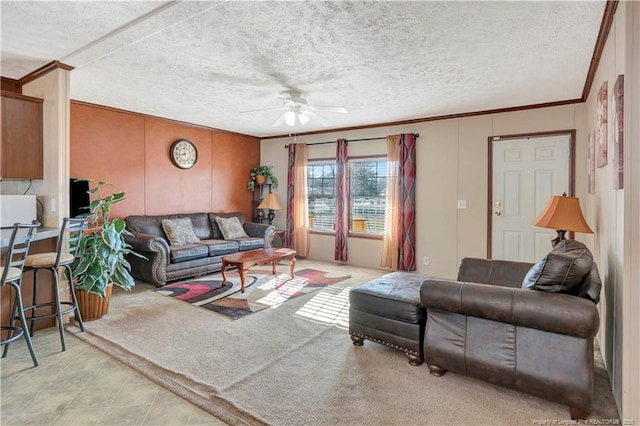 living room with a textured ceiling, ceiling fan, and crown molding