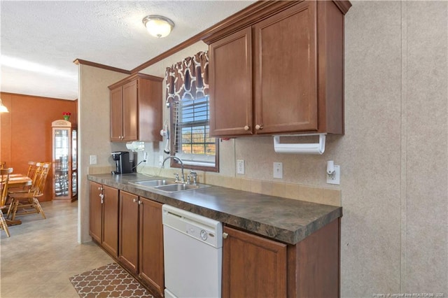 kitchen with dark countertops, brown cabinetry, a sink, a textured ceiling, and dishwasher