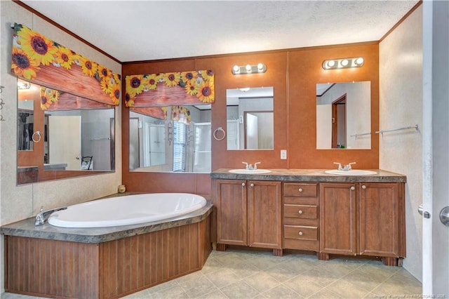 full bathroom featuring a garden tub, double vanity, ornamental molding, and a sink