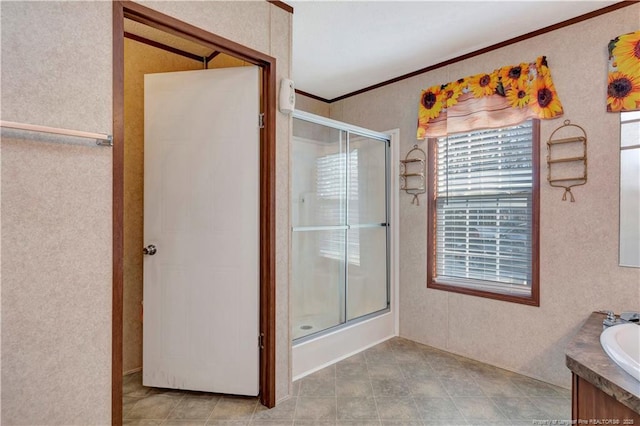 full bathroom with a shower stall, crown molding, and vanity