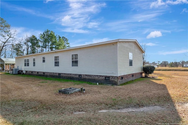 view of home's exterior with central AC and crawl space