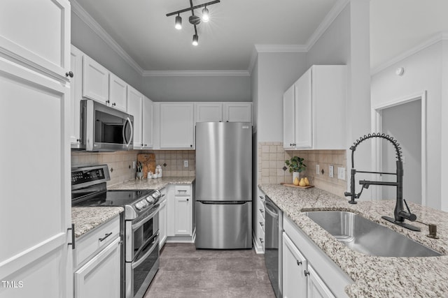 kitchen with appliances with stainless steel finishes, white cabinets, and a sink