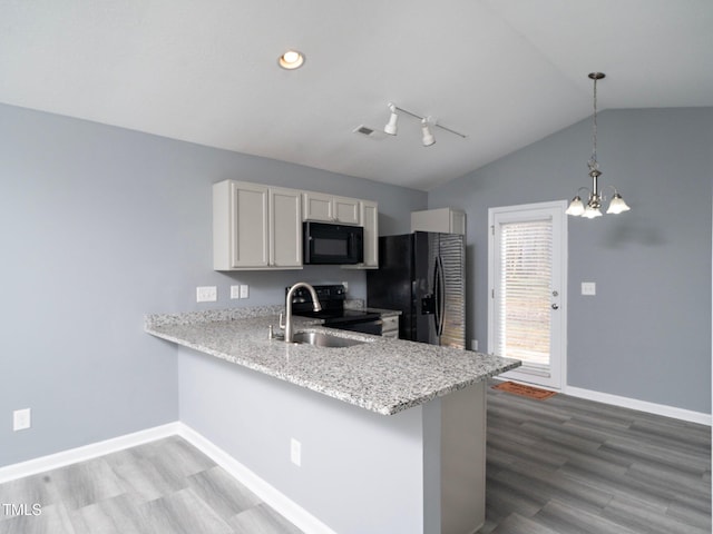 kitchen with black appliances, white cabinets, hanging light fixtures, vaulted ceiling, and kitchen peninsula