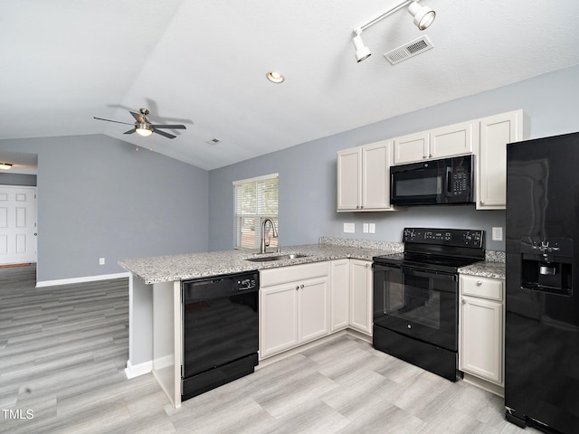 kitchen with kitchen peninsula, white cabinetry, sink, and black appliances