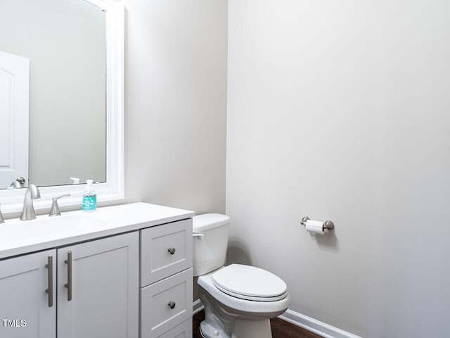 bathroom with toilet and vanity