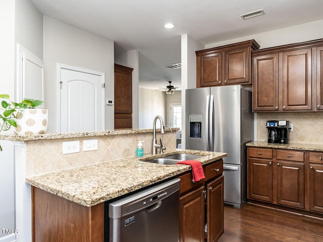 kitchen with dishwashing machine, ceiling fan, dark wood-type flooring, decorative backsplash, and sink