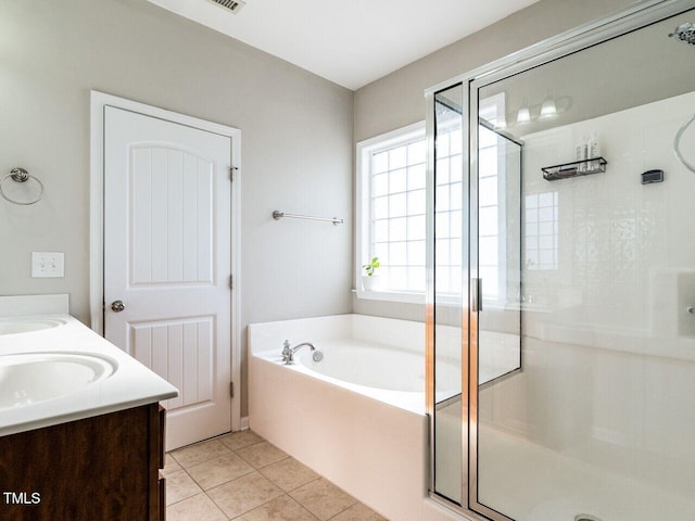 bathroom with independent shower and bath, tile patterned flooring, and vanity