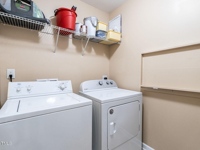 clothes washing area with washer and clothes dryer