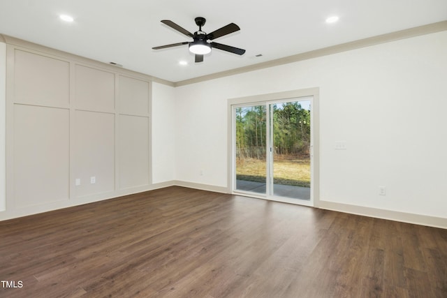 empty room with ceiling fan, dark hardwood / wood-style flooring, and ornamental molding