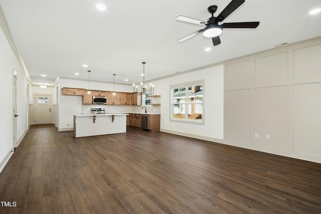 kitchen with stainless steel appliances, a center island, dark hardwood / wood-style floors, and hanging light fixtures