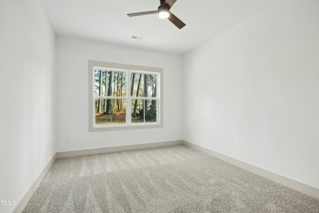 carpeted spare room with ceiling fan