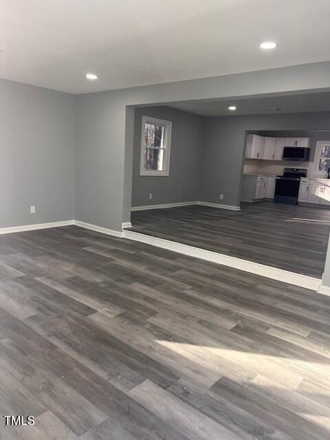 unfurnished living room with dark wood-type flooring