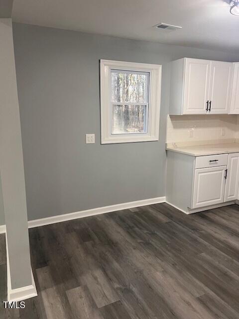 108 Seabreeze Rd, Hertford, NC 27944 - unfurnished dining area featuring dark wood finished floors and baseboards