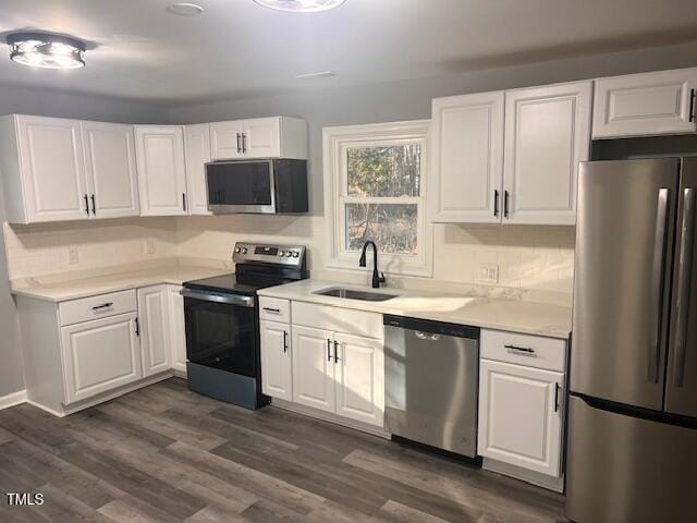 108 Seabreeze Rd, Hertford, NC 27944 - kitchen with appliances with stainless steel finishes, white cabinets, light countertops, and dark wood finished floors