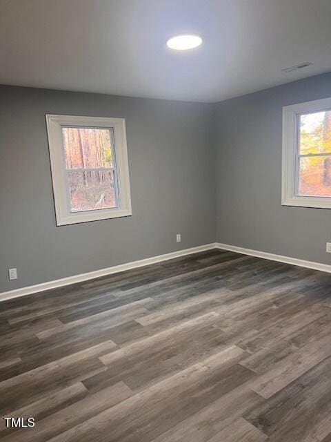 unfurnished room featuring dark wood-type flooring