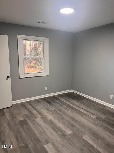 empty room featuring dark wood-type flooring