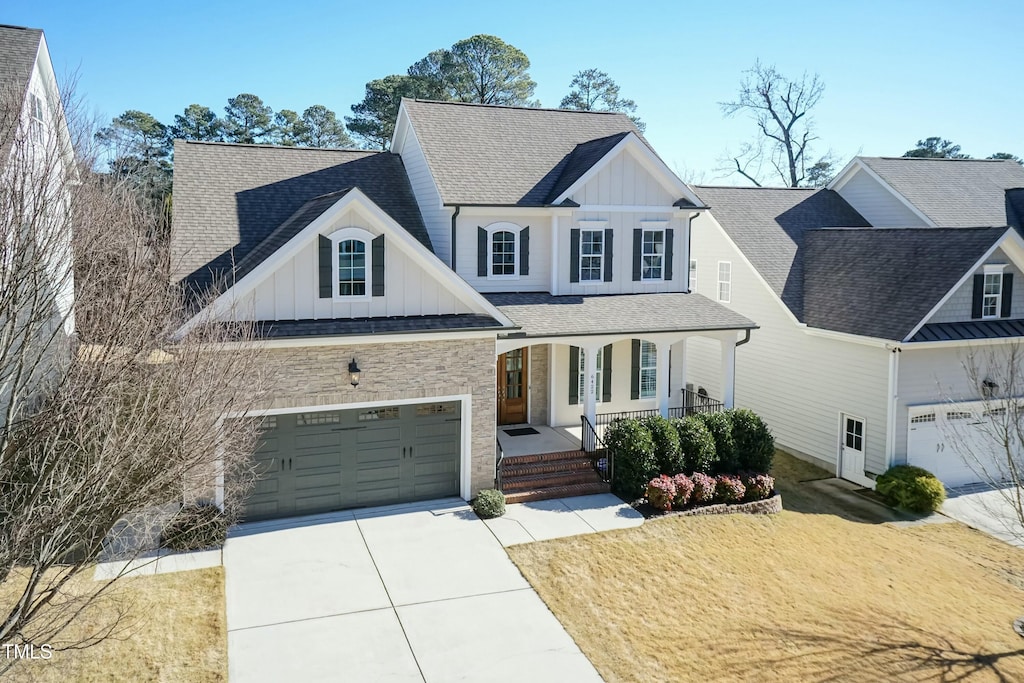 view of front of home featuring a porch and a garage