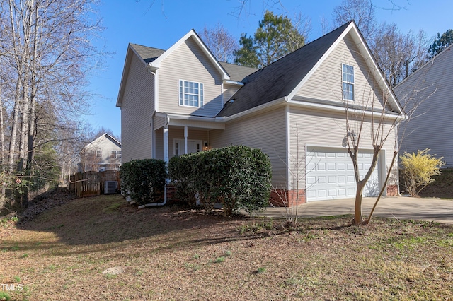 view of side of property with an attached garage and concrete driveway