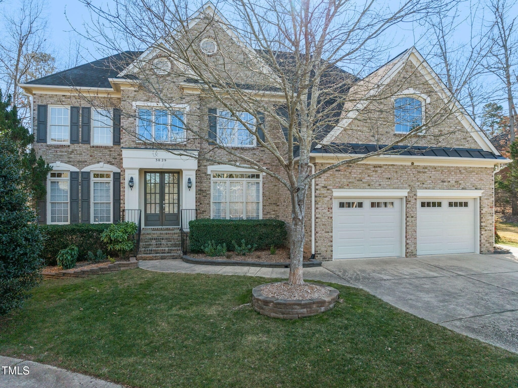 view of front of home with a front yard and a garage