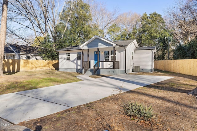 bungalow-style home with central AC and a front yard