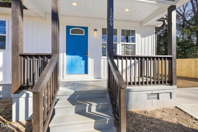 view of exterior entry with a porch