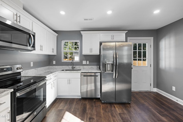 kitchen with white cabinetry, light stone countertops, sink, and appliances with stainless steel finishes