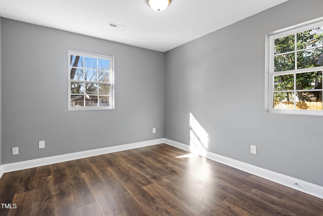 spare room featuring dark hardwood / wood-style flooring