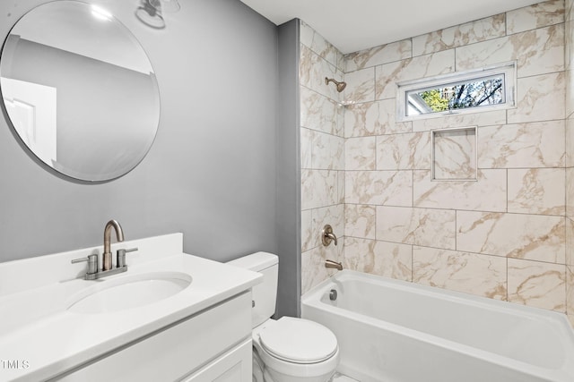 full bathroom with vanity, toilet, and tiled shower / bath