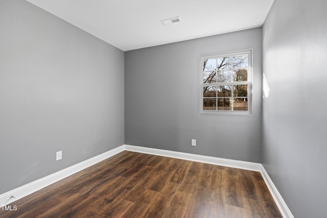 spare room featuring dark hardwood / wood-style floors