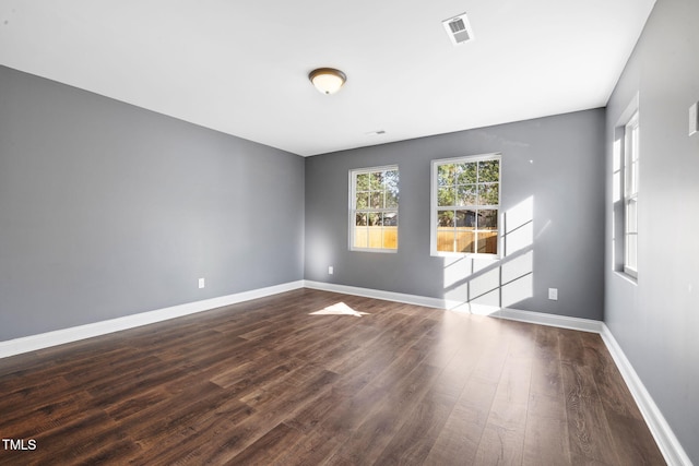 empty room featuring dark hardwood / wood-style flooring