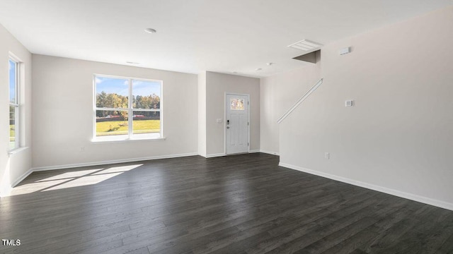 interior space with dark wood-style flooring and baseboards