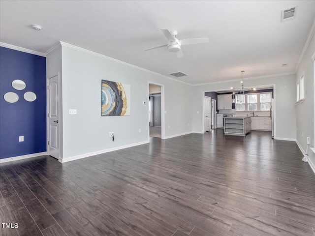 unfurnished living room featuring ornamental molding, dark wood-type flooring, sink, and ceiling fan with notable chandelier