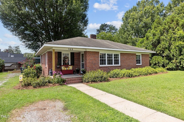 view of front of house with a porch and a front lawn