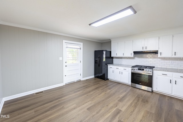 kitchen featuring stainless steel gas range oven, white cabinetry, black fridge with ice dispenser, and light hardwood / wood-style flooring