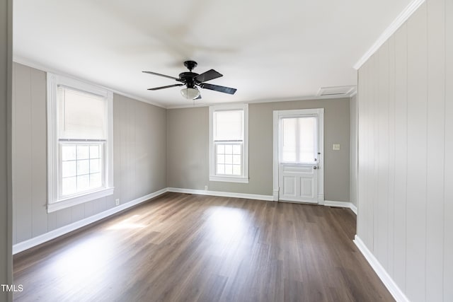 spare room featuring ceiling fan, dark wood-type flooring, and ornamental molding