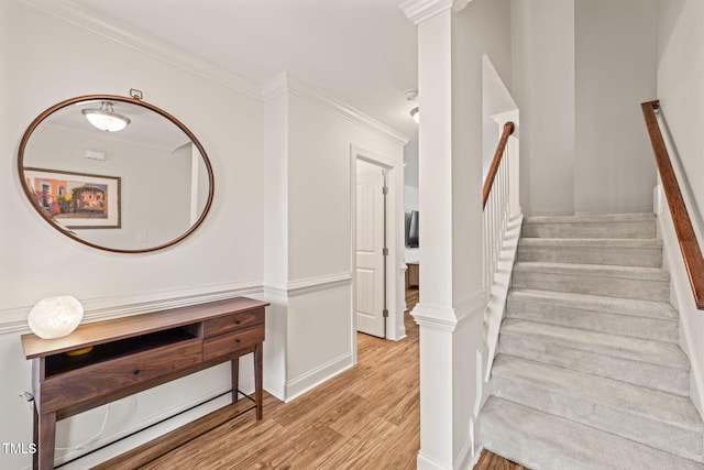 stairs with crown molding and hardwood / wood-style flooring