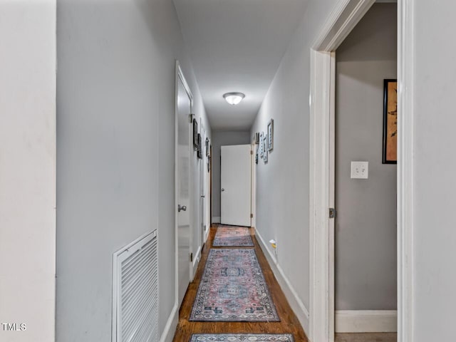 corridor with dark hardwood / wood-style floors