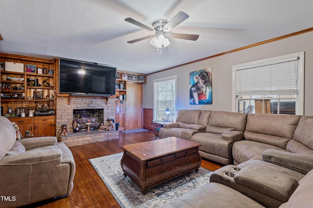 living room featuring ornamental molding, dark wood-type flooring, and ceiling fan