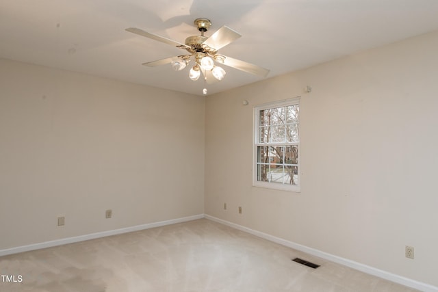 empty room featuring ceiling fan and light colored carpet