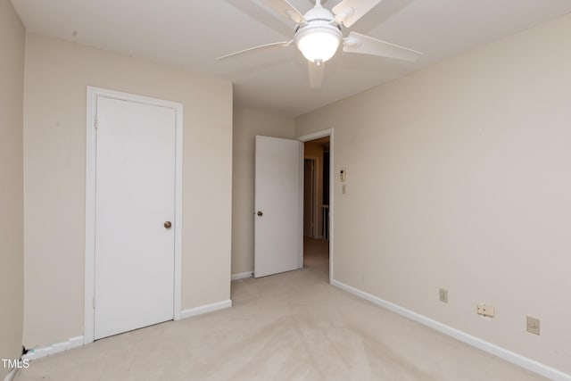 unfurnished bedroom with ceiling fan and light carpet